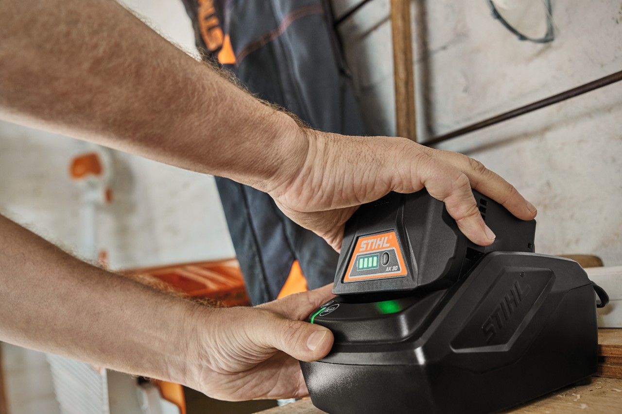 STIHL AK 30 lithium-ion battery being charged in a charging station