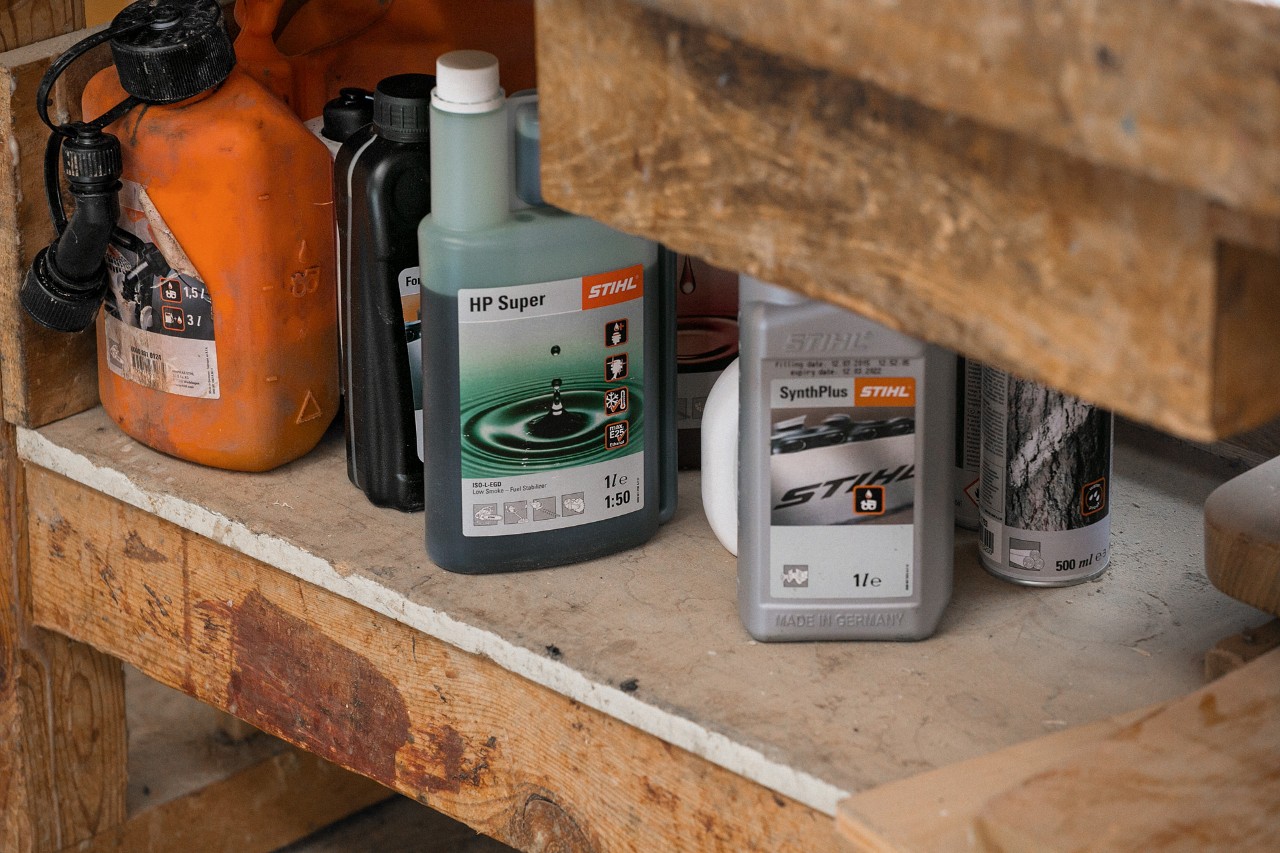 STIHL SynthPlus chain oil and STIHL HP Super two-stroke engine oil next to other fuels on a shelf