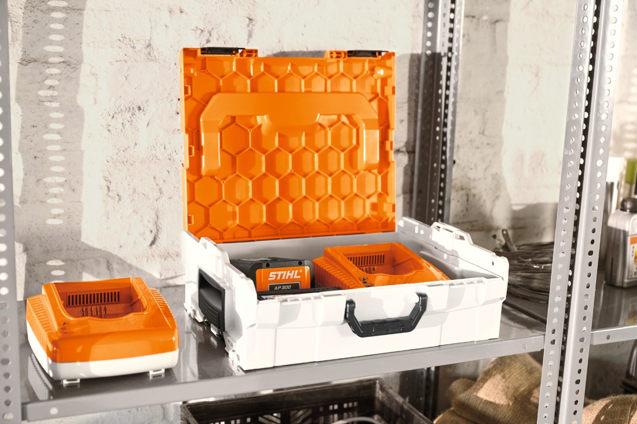 STIHL battery box with STIHL batteries on a workshop shelf  
